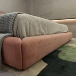 Soft Pink Upholstered Bed with Oversized Cushion Headboard & Rounded Base